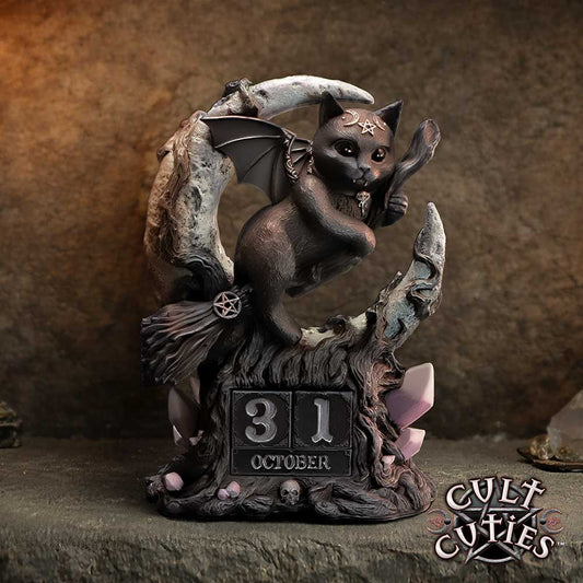 Malpuss Cult Cuties perpetual calendar by Nemesis Now featuring Malpuss riding a broom within a crescent moon with black wooden date and month blocks