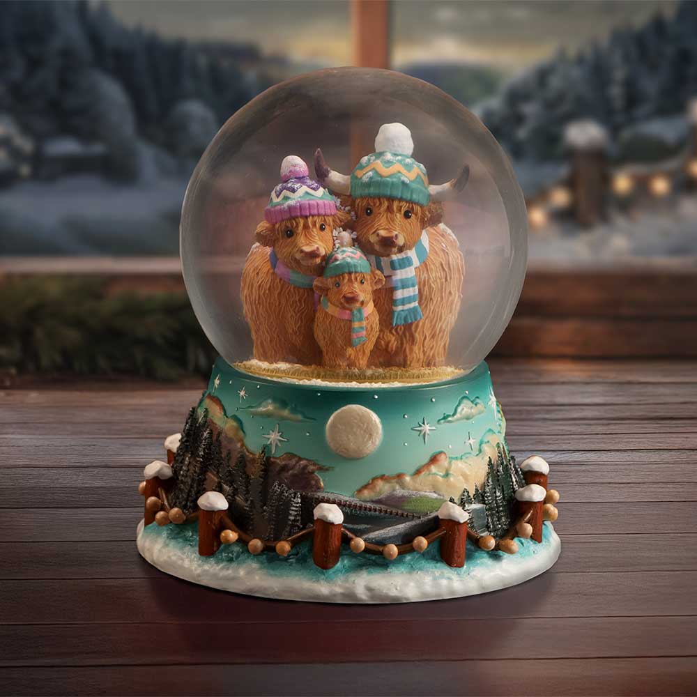 Winter Highland Cow Family Snow Globe - Cow family snow globe in a styled winter setting