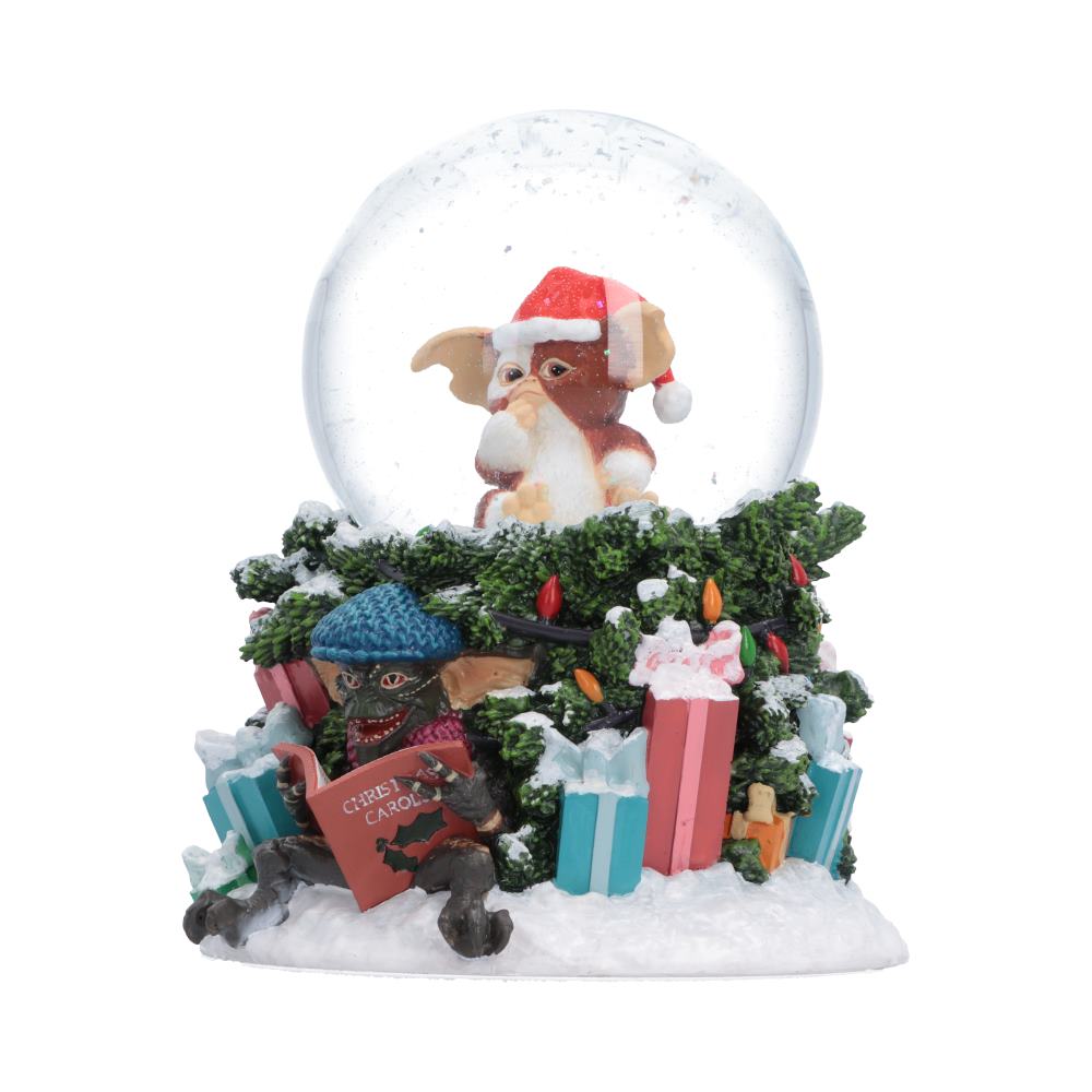 Gremlins Christmas Carol Snow Globe - Angled view of festive greenery presents and open songbook