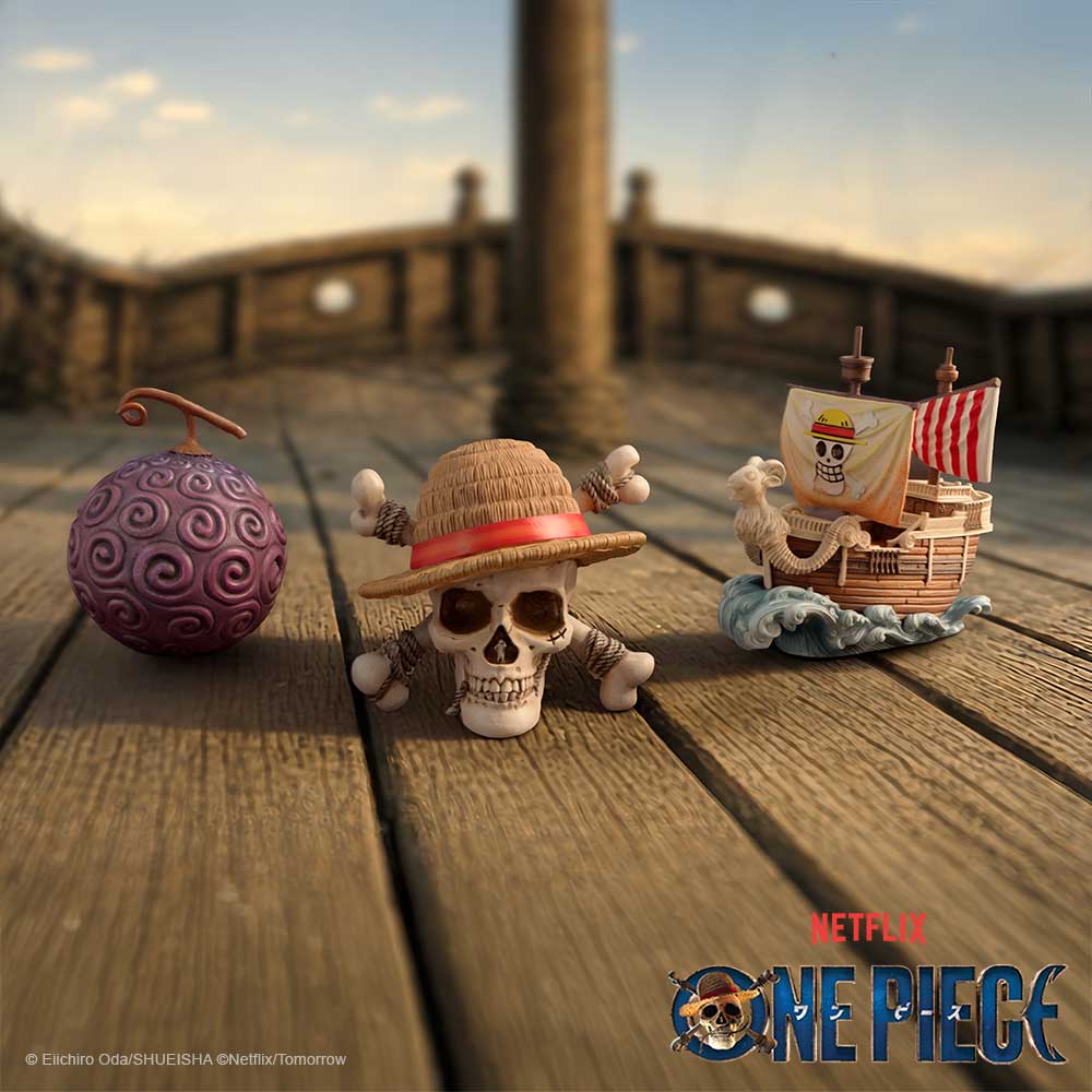 One Piece First Voyage Mini Figurines Set - three miniatures on a waterfront display with One Piece branding