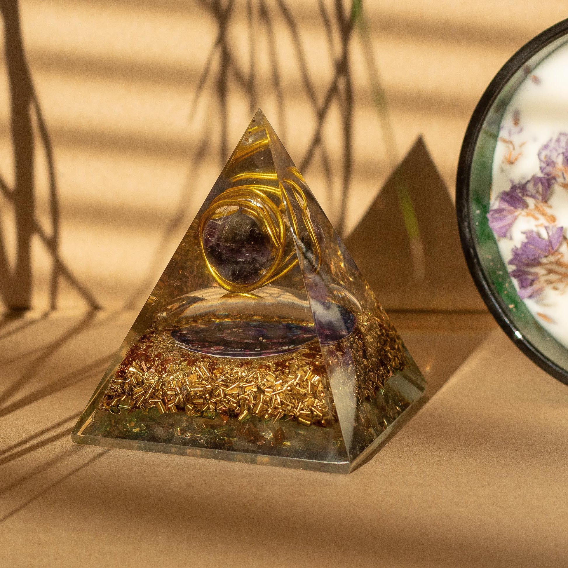 Medium orgonite pyramid with wrapped copper and amethyst gemstone chips in handcrafted resin.