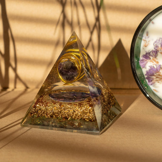 Medium orgonite pyramid with wrapped copper and amethyst gemstone chips in handcrafted resin.