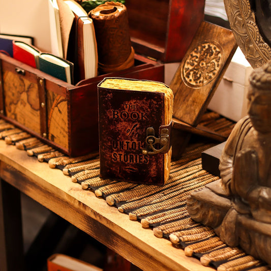 Book of Untold Stories Leather Journal – deckle edge journal with embossed quote and clasp closure