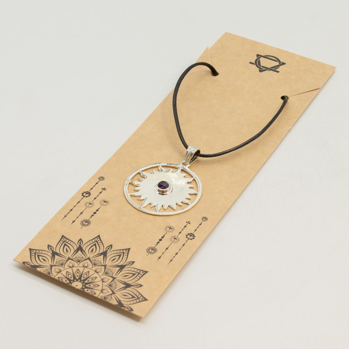 Silver plated Sun Worship pendant with radiant openwork sun design, polished purple Amethyst gemstone and 45cm black cord for spiritual jewellery UK
