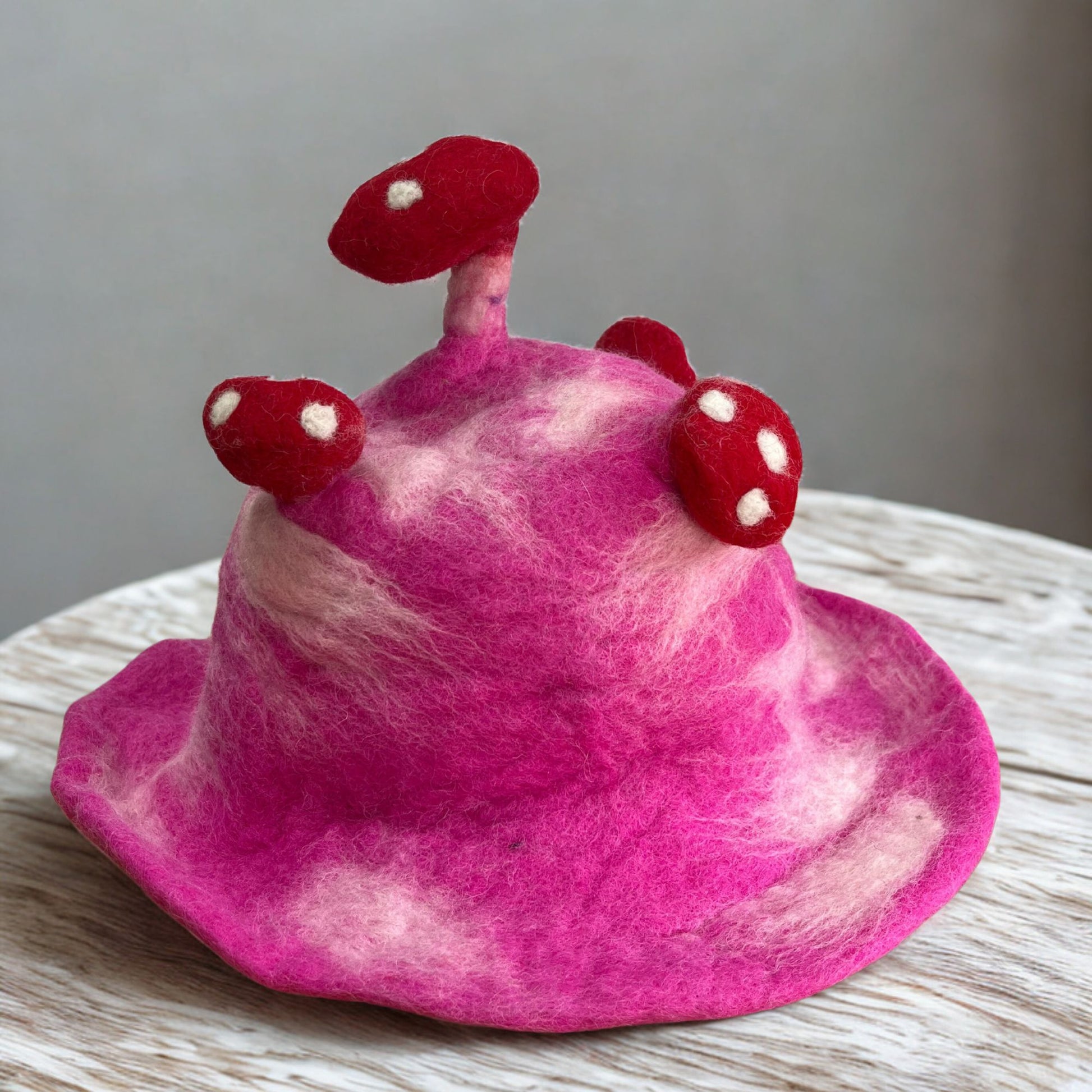 Felted Mushroom Hat in shocking pink felted wool with rounded silhouette
