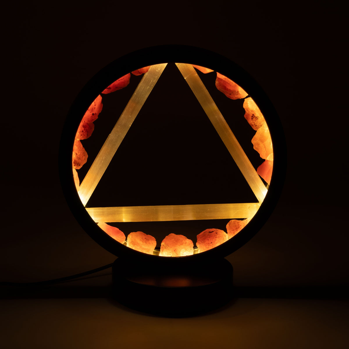 Fire Gemstone Halo Lamp with carnelian halo and selenite Fire symbol illuminated on black metal stand UK