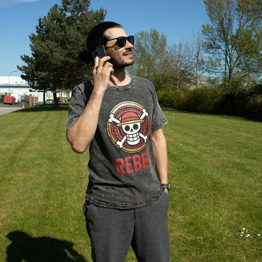 Small Nomad Sari Stonewashed Cotton T-Shirt in charcoal with Rebel design and soft double stonewashed cotton finish.