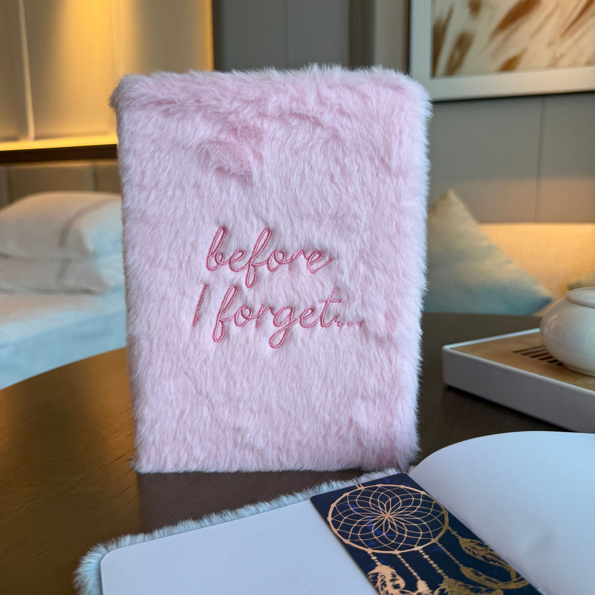 Pastel pink soft dream journal with embroidered Before I Forget wording on the cover