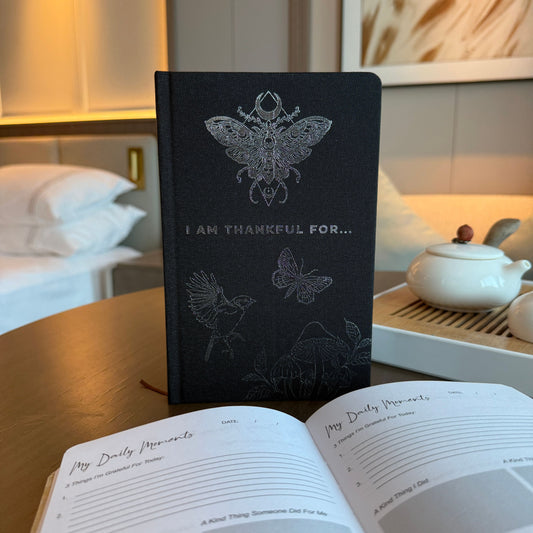Black I Am Thankful For gratitude journal with silver moon, stars and botanical celestial detailing