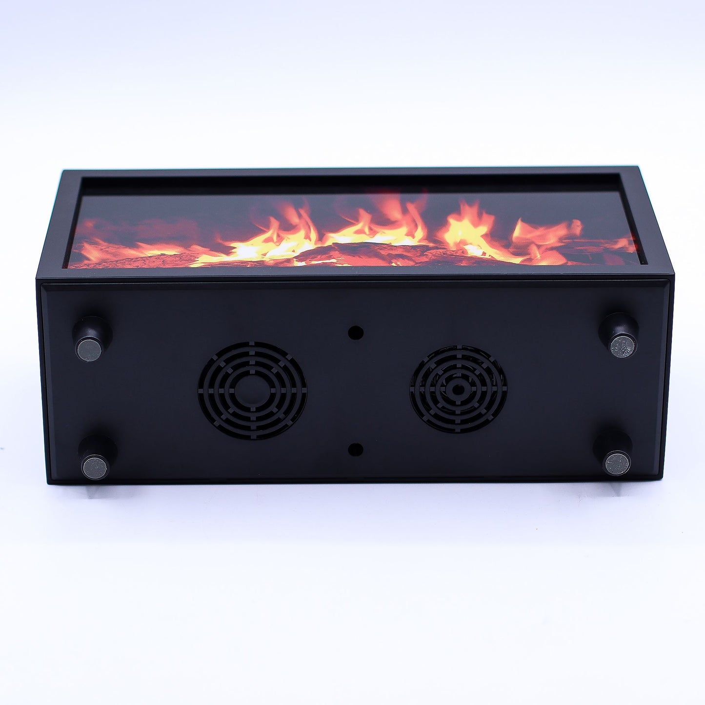 Rectangular black electric fireplace box displays simulated flames through top glass while underside shows two circular fan vents and four rubber feet on a white surface