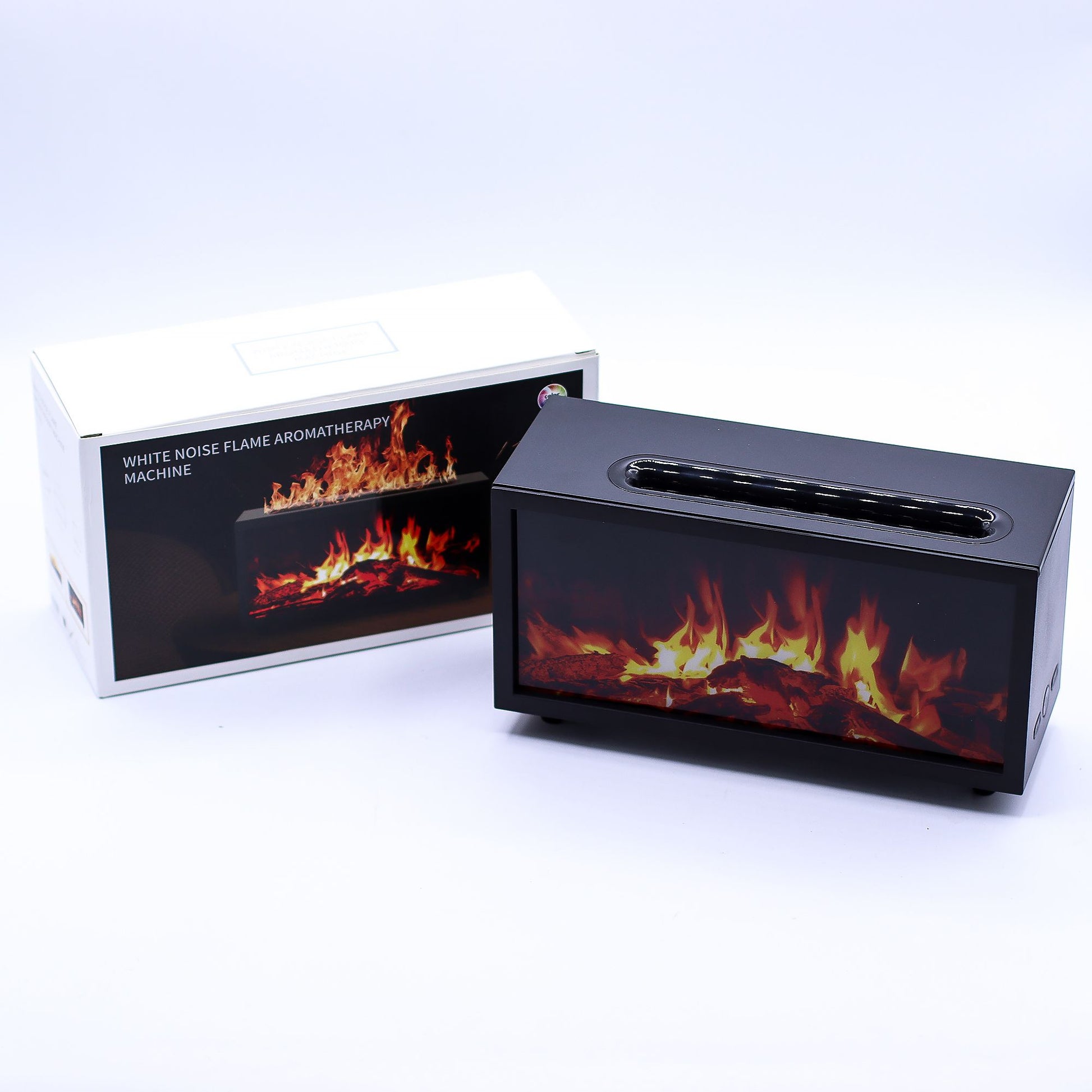 Black rectangular aromatherapy machine simulating dancing flames while sitting on a white surface with its box behind it; box text reads WHITE NOISE FLAME AROMATHERAPY MACHINE