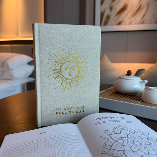 Ivory gratitude journal with gold detailing and My Days Are Full of Sun wording on the cover