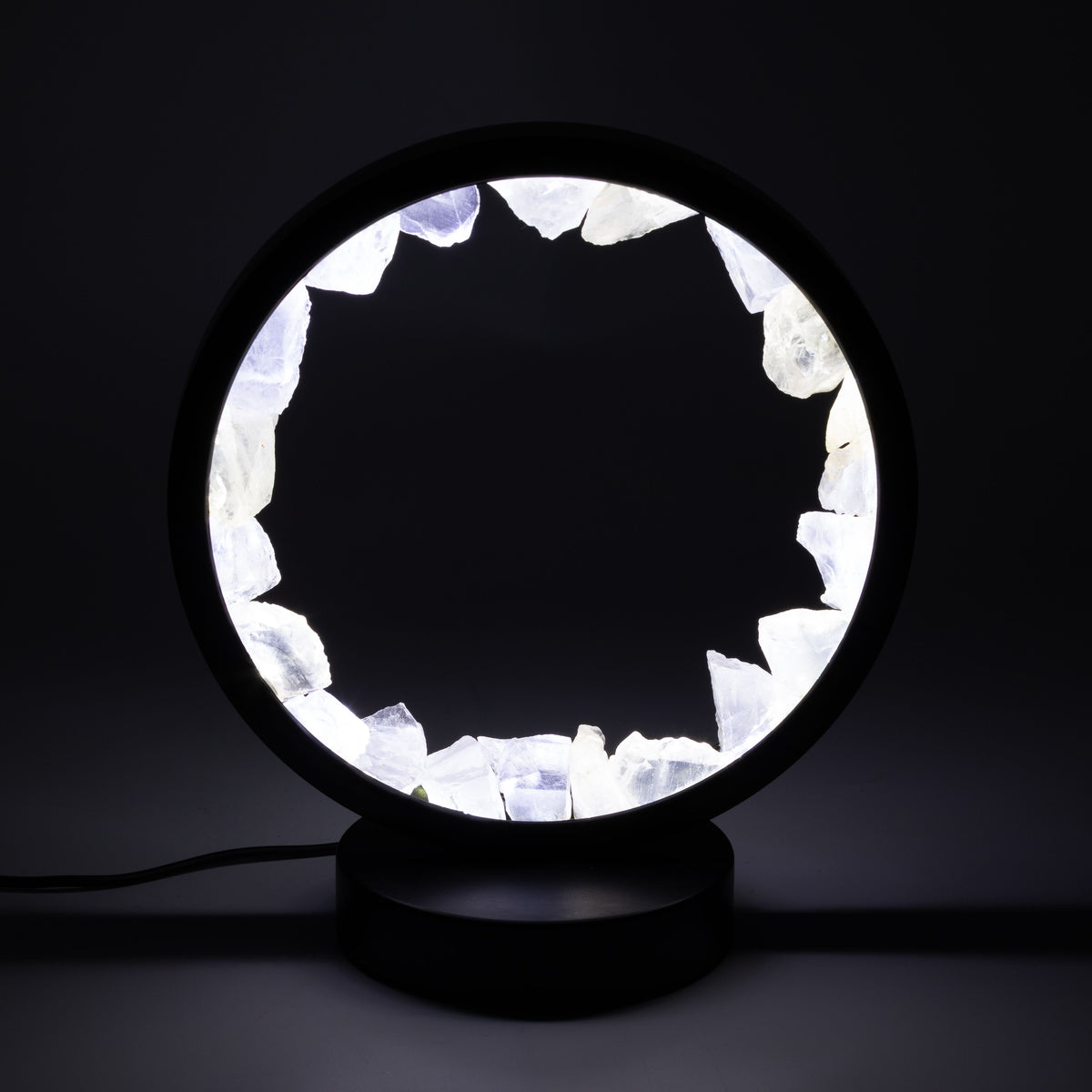 Zen Mind clear quartz Gemstone Halo Lamp glowing white on black metal stand UK