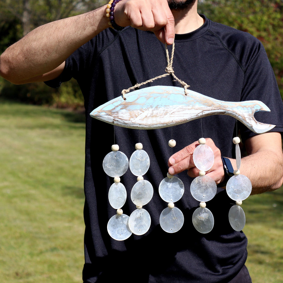 Handmade bluewashed driftwood fish windchime with natural Capiz shell drops.