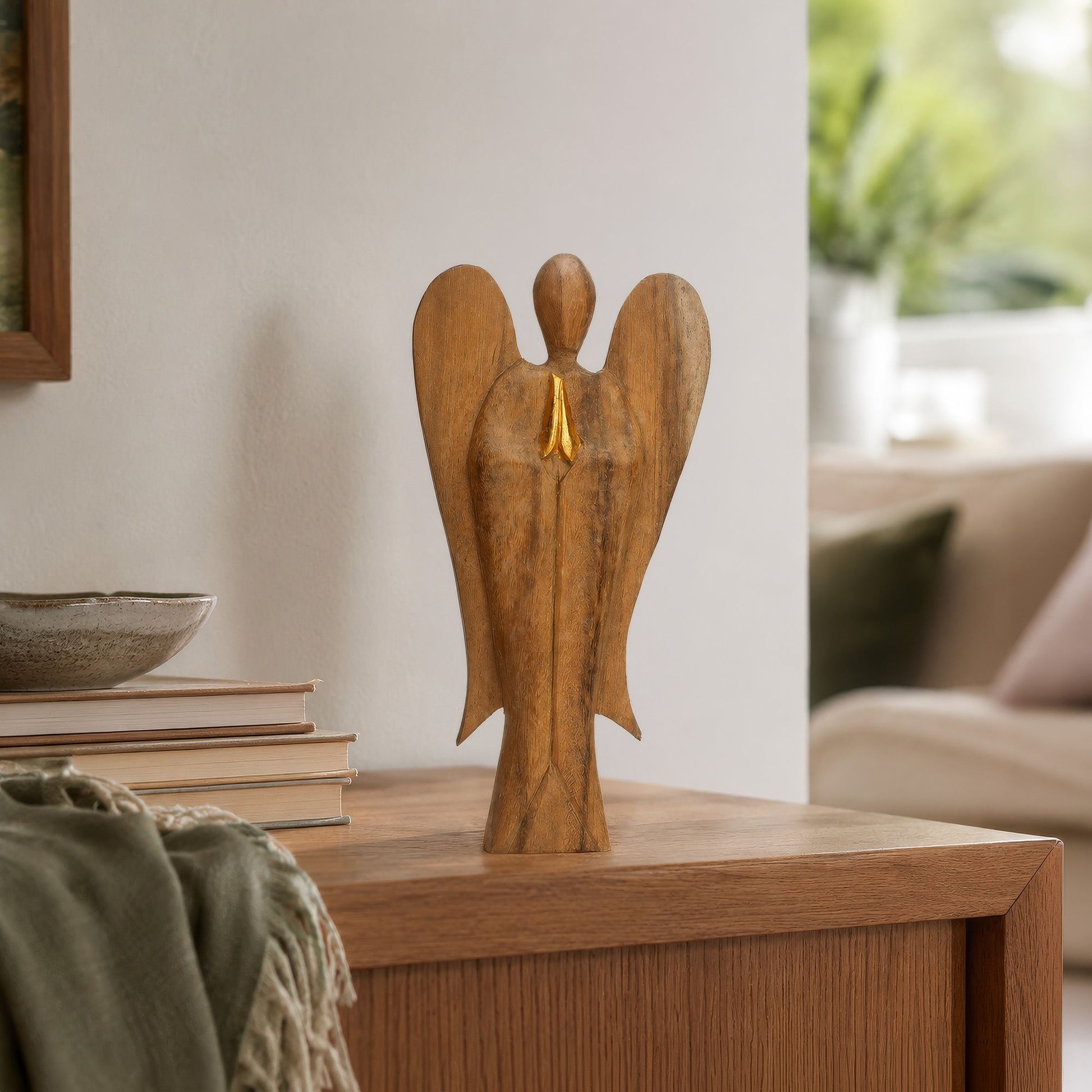 Hand-carved Hati Hati Friendship angel in Suar wood with gold-painted details and natural wood grain