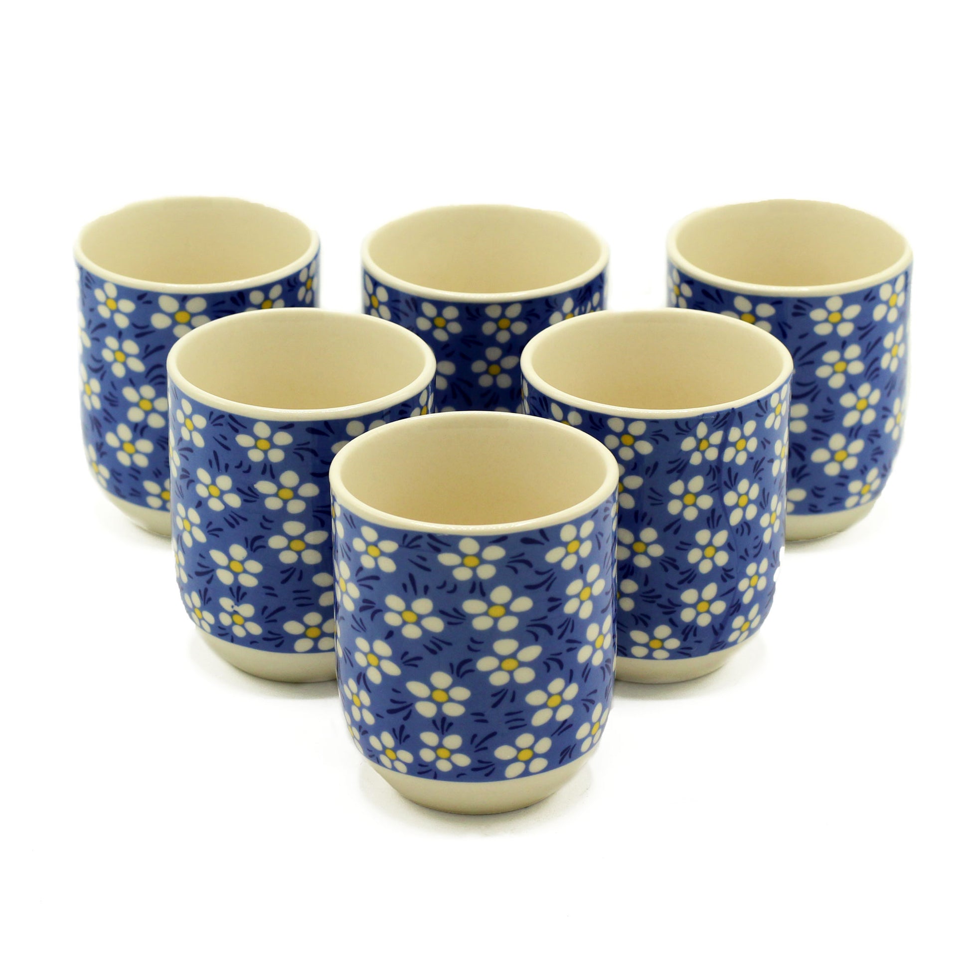 Six small, blue floral-patterned mugs sit on a white background.