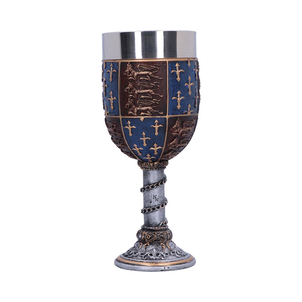 A decorative goblet features a silver top and a blue-and-brown body patterned with crosses and heraldic lions. Its stem is a silver twisted rope marked with “N”.