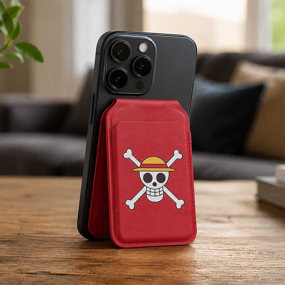 One Piece Jolly Roger MagSafe Card Holder Red - Red Jolly Roger holder attached to phone on wooden table