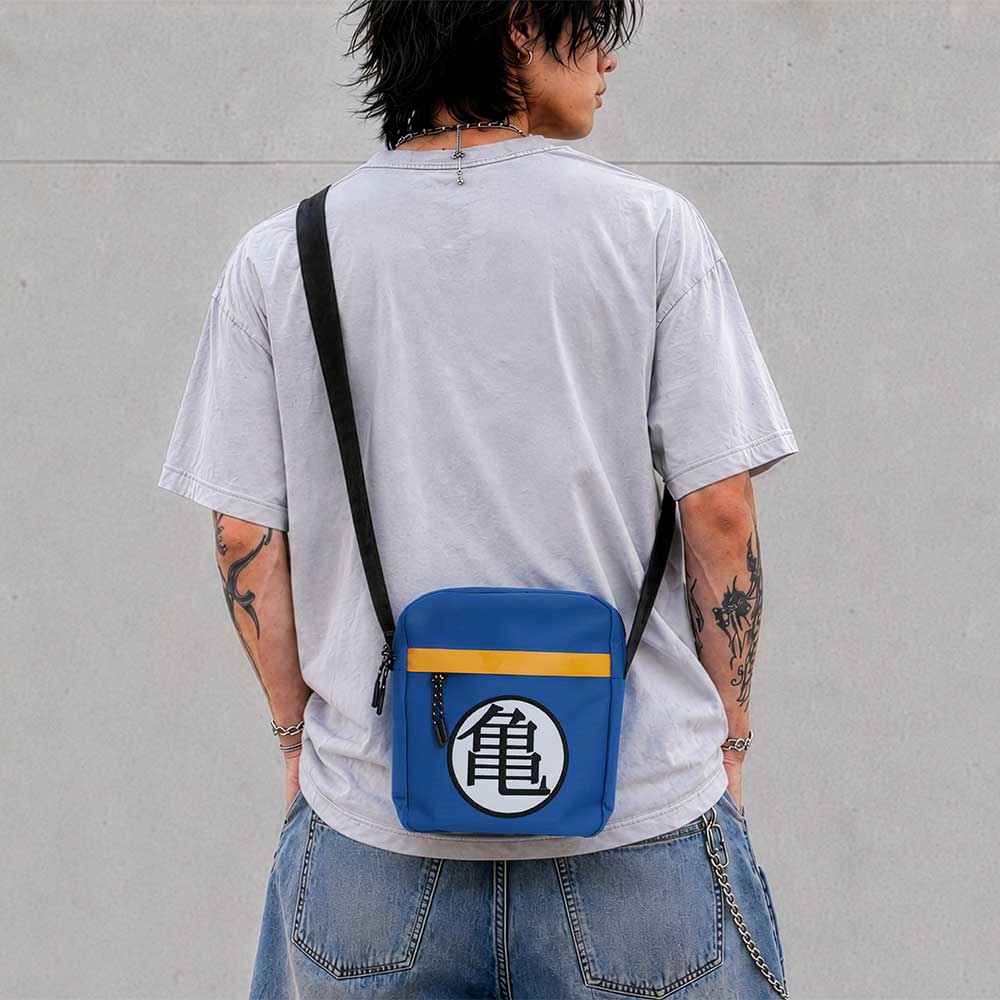 Dragon Ball Z Kame Symbol Crossbody Bag - Blue Kame symbol bag worn with a pale grey top