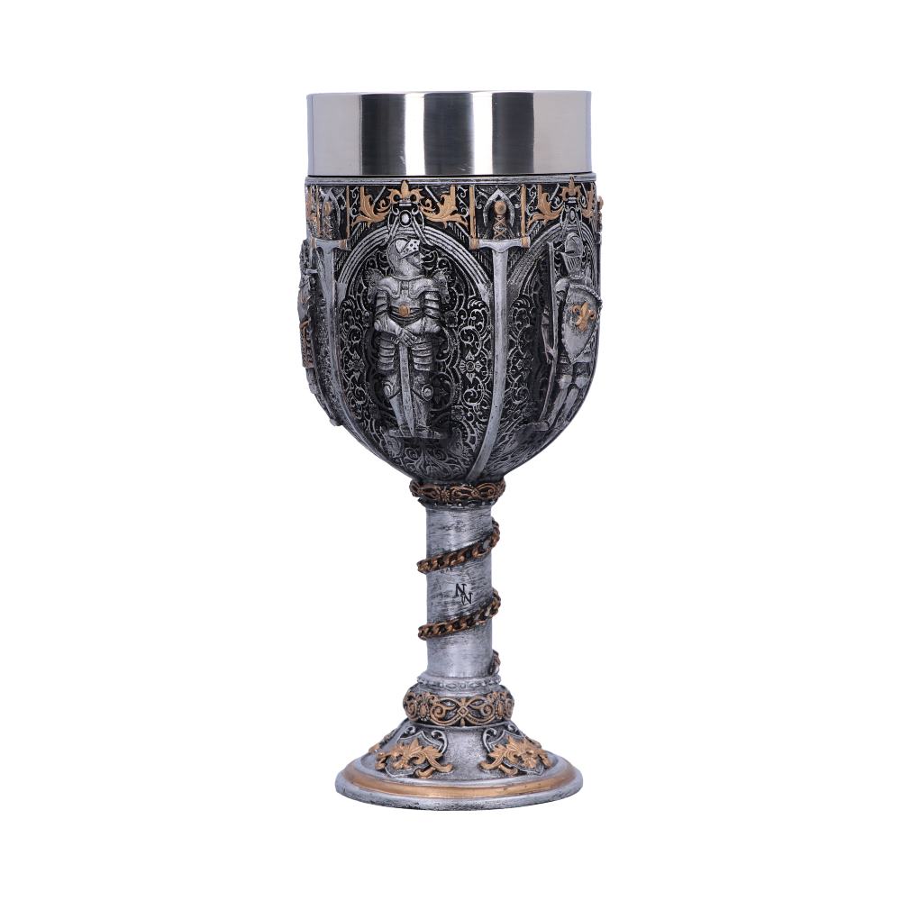 An ornate silver goblet sits on a white surface. It features knight figures and decorative gold accents on its body and base, with a twisted, chain-like stem displaying a stylized "N" letter.