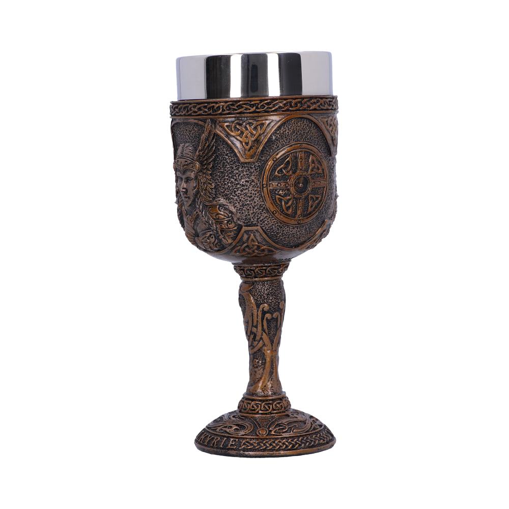 A goblet stands on a white surface. It features carvings of a winged warrior and a shield, with "VALKYRIES" inscribed on its base, and a shiny silver top.
