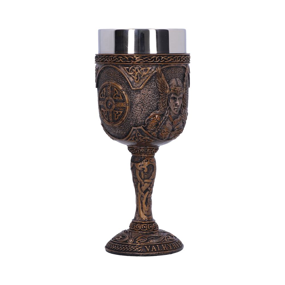 A decorative goblet sits on a white surface, displaying an ornate bronze-colored design featuring a valkyrie and Celtic patterns, topped with a plain silver-colored metal cup. The text “VALKYRI” appears on the base.