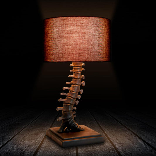 Vertebrae lamp with realistic resin spine stem and dark fabric shade
