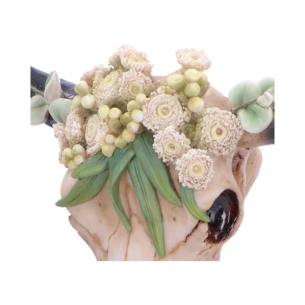 Floral Crown Bull Skull Wall Ornament - Close detail of cream blossoms and green leaves