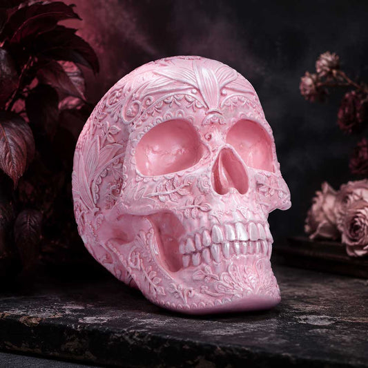 Eternal Bloom Floral Skull Ornament - pink floral skull displayed beside pale flowers