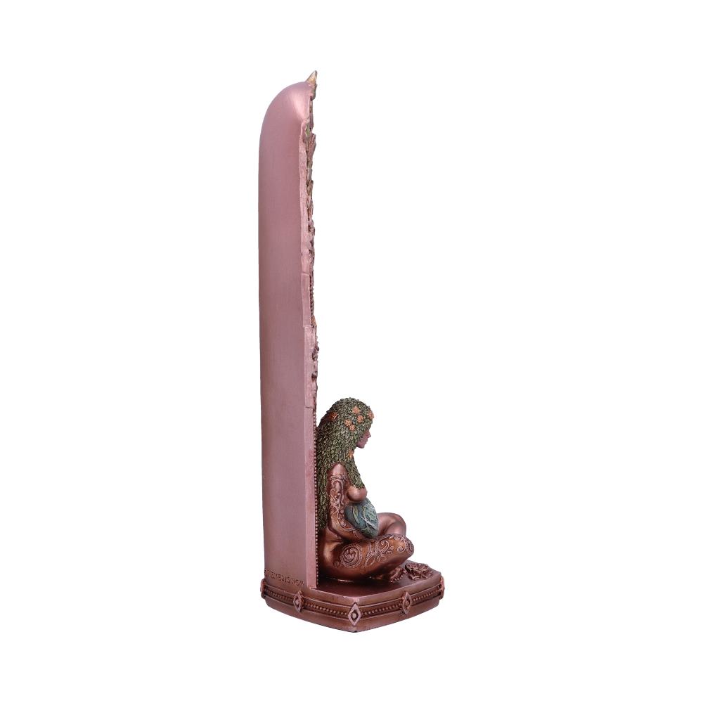 A bronze-colored statue of a seated woman, possibly pregnant, rests against a tall, flat, textured backing. The statue and backing are situated on a base.  The word “DREAMSCAPE” is partially visible on the base.