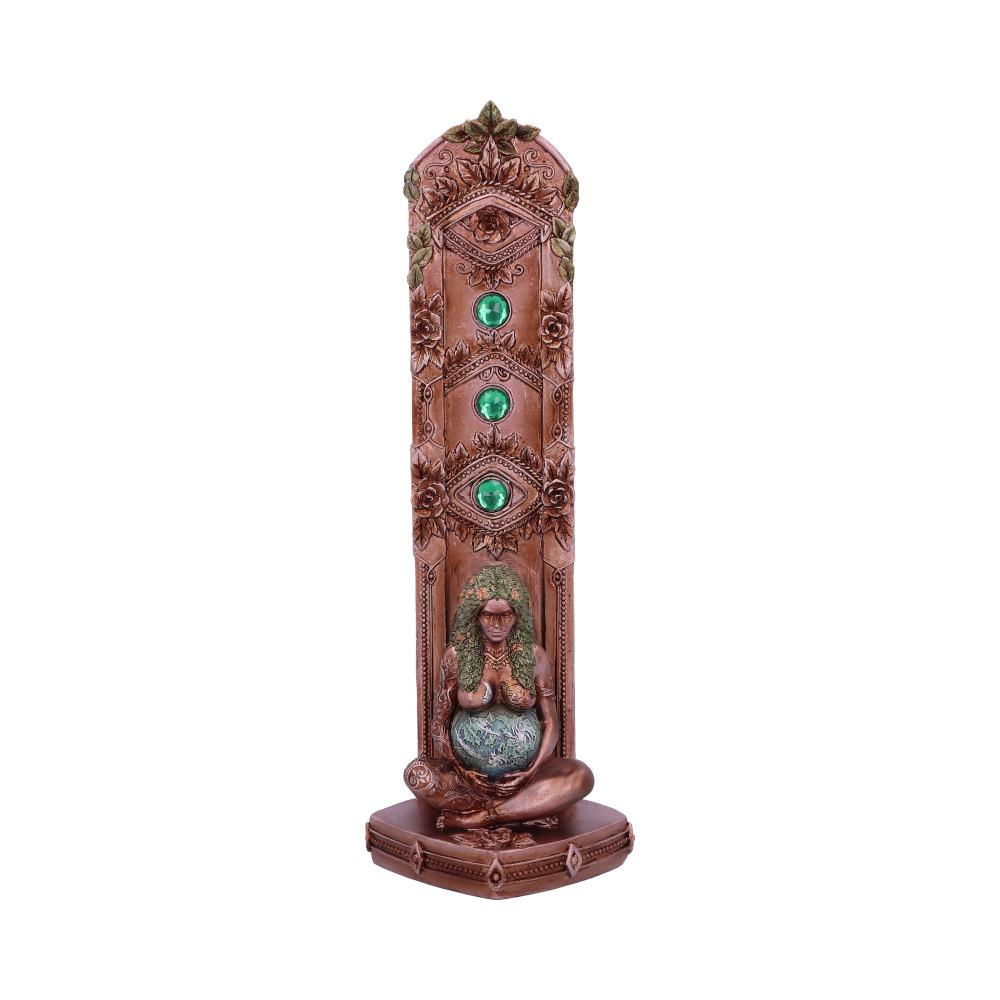 A bronze incense burner, featuring a seated goddess figure holding a sphere, stands against a white background.  Three green gems adorn the burner's central panel.