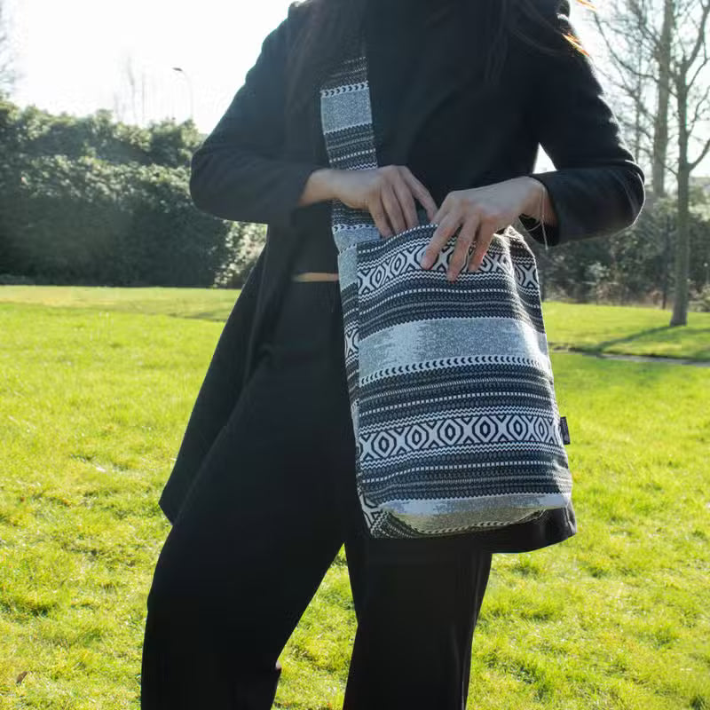 Urban Caravan Nomad Carryall sling bag in black and natural cotton-viscose jacquard with geometric woven pattern