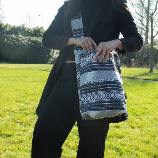 Urban Caravan Nomad Carryall sling bag in black and natural cotton-viscose jacquard with geometric woven pattern
