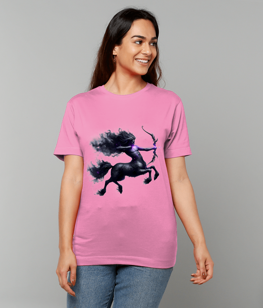 Centaur archer graphic gallops and draws a glowing bow printed on a pink T-shirt worn by a smiling person standing against a plain light-gray studio background.