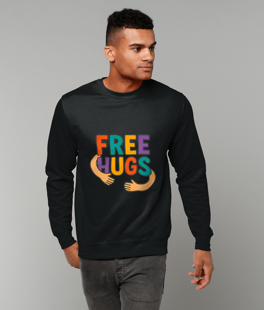 Black sweatshirt displays text FREE HUGS and cartoon hugging arms worn by a man standing and looking right against a plain light gray studio background.