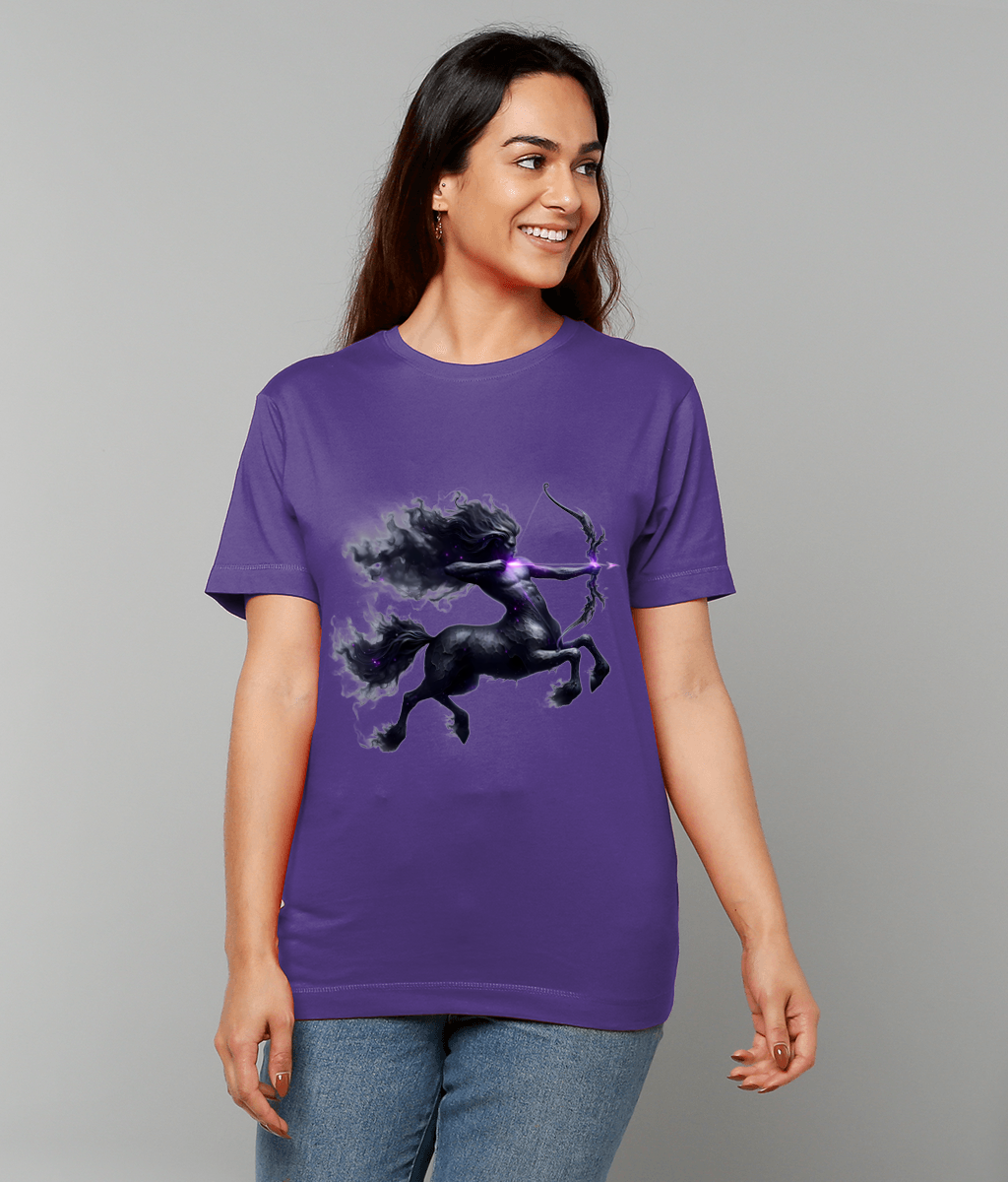 Purple T-shirt depicting a dark centaur archer drawing a glowing purple bow, worn by a smiling person facing right in casual jeans against a plain light gray background.