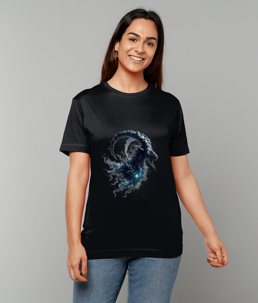 Woman wearing a black t-shirt displaying a glowing mythic ram head design, standing and smiling against a plain light-gray background.