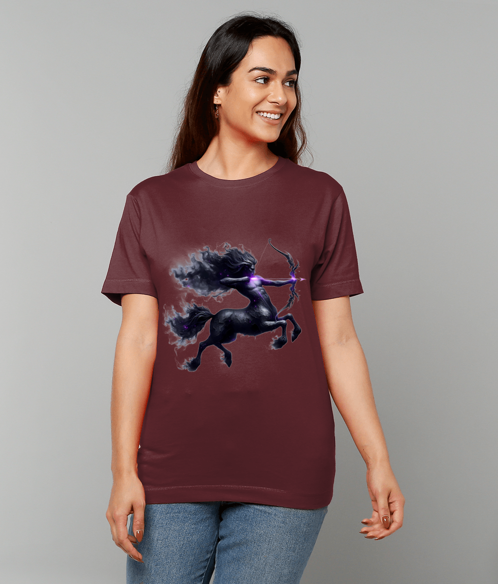 Maroon t-shirt displaying a dark centaur archer drawing a glowing purple bow, worn by a smiling woman standing and looking right against a plain grey background.