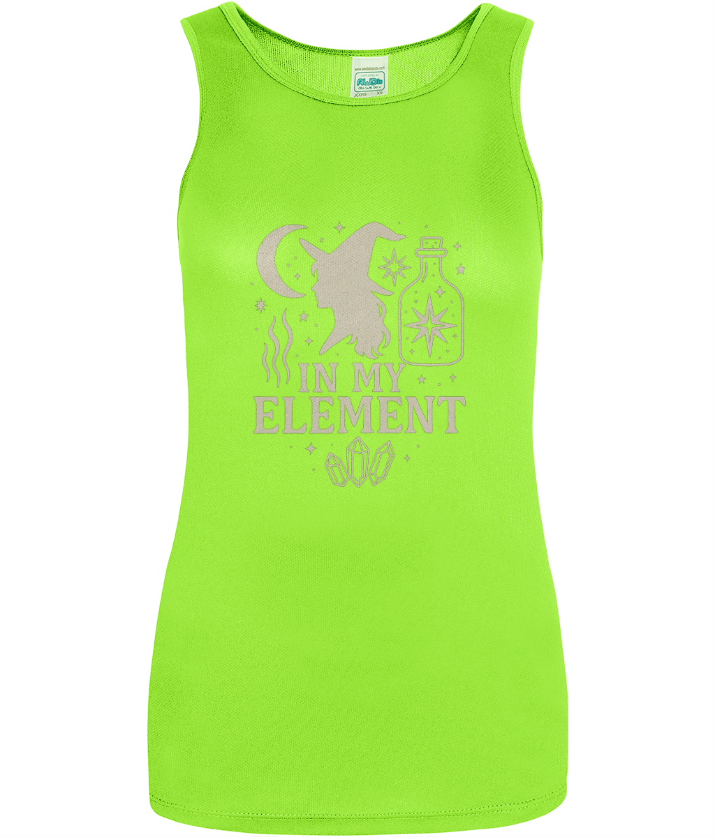 Lime green sleeveless tank top displays a witch silhouette, crescent moon, potion bottle, stars, crystals and the text IN MY ELEMENT on the front against a white background.