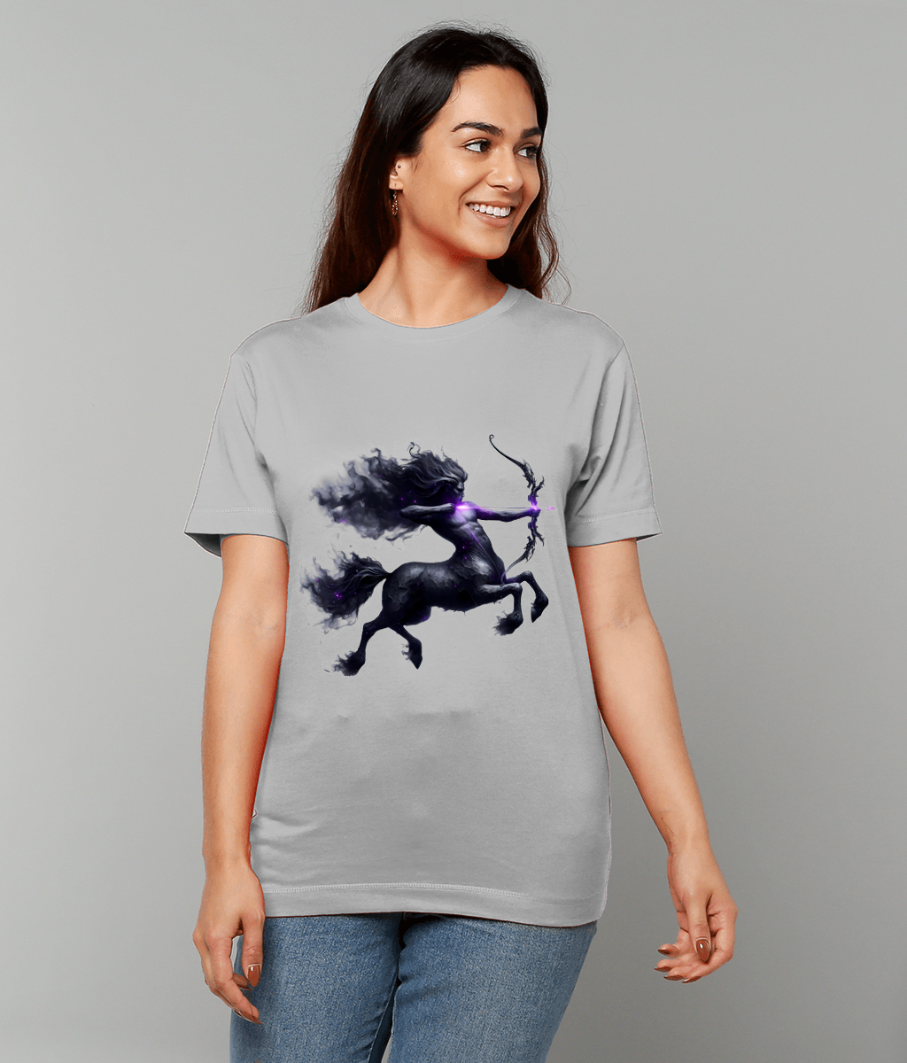 Light gray T-shirt displays a dark ethereal centaur drawing a glowing purple bow, rearing amid smoky mane and tail, worn by smiling woman standing against a plain light gray background.