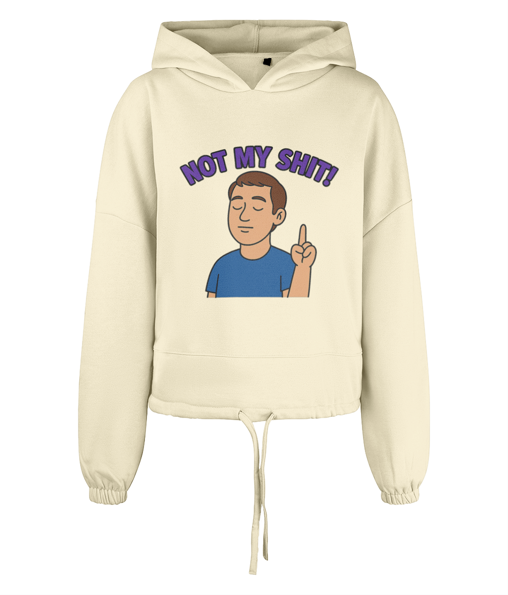 Hoodie displays text "NOT MY SHIT!" in purple above a cartoon man with closed eyes raising one finger on a cream cropped hoodie set against a solid black background.