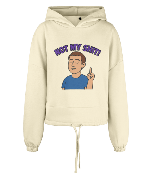 Hoodie displays text "NOT MY SHIT!" in purple above a cartoon man with closed eyes raising one finger on a cream cropped hoodie set against a solid black background.