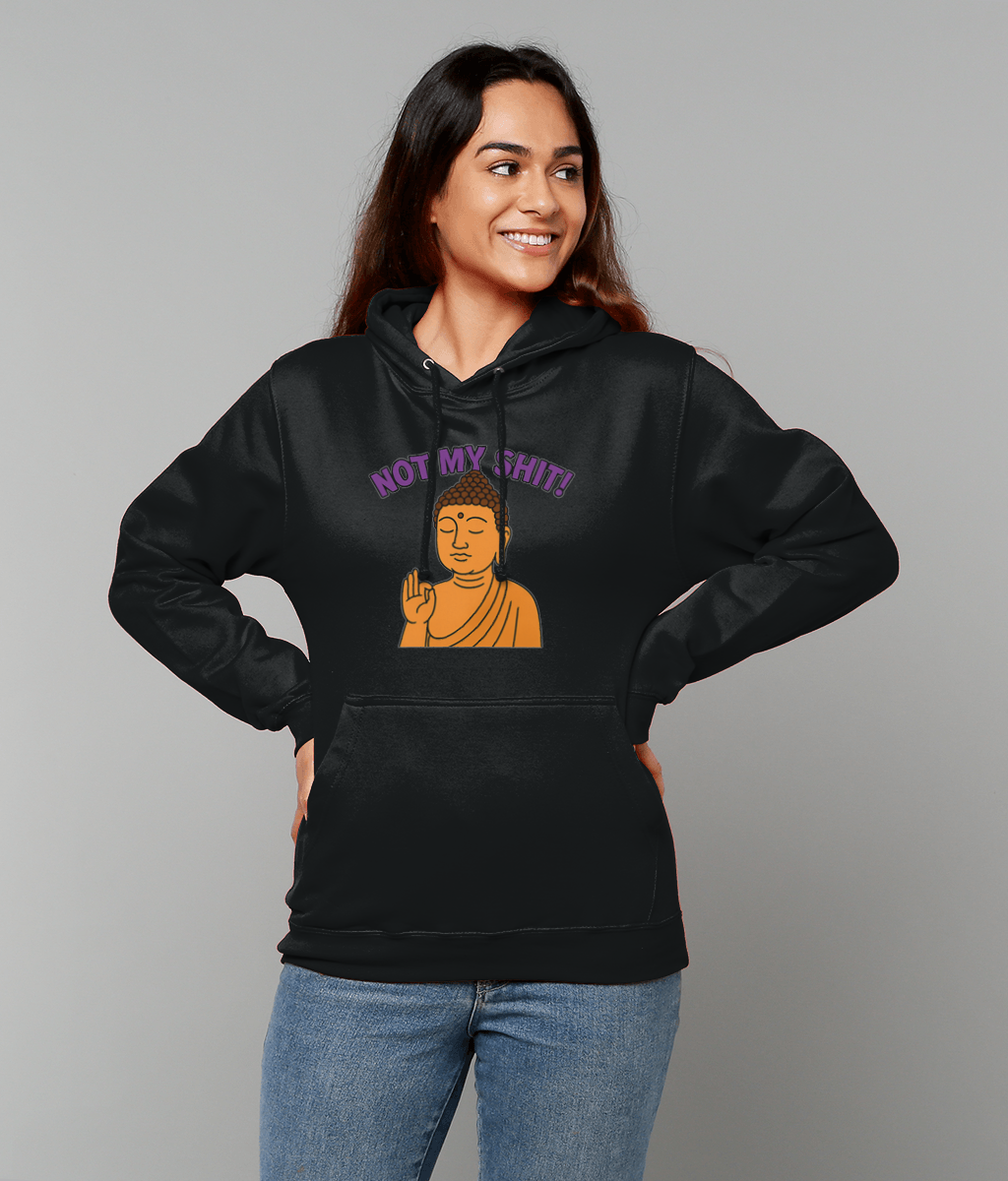 Person wearing a black hoodie printed with an orange Buddha making a hand gesture and the text "NOT MY SHIT!" above it, standing with hands on hips against a gray background.