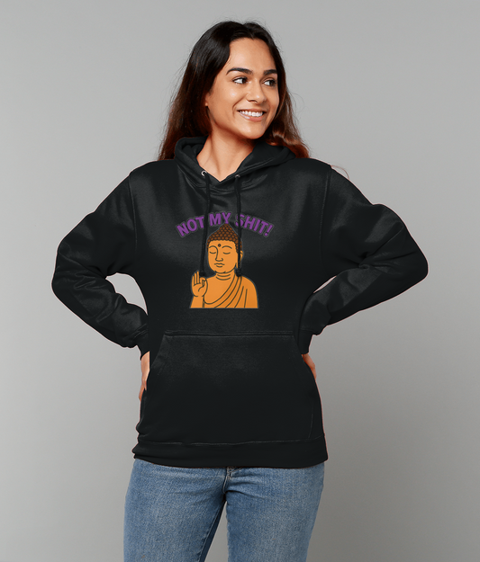 Person wearing a black hoodie printed with an orange Buddha making a hand gesture and the text "NOT MY SHIT!" above it, standing with hands on hips against a gray background.
