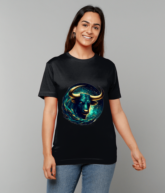 Bull illustration surges with turquoise and gold energy on a black t-shirt worn by a smiling person standing against a plain gray background.