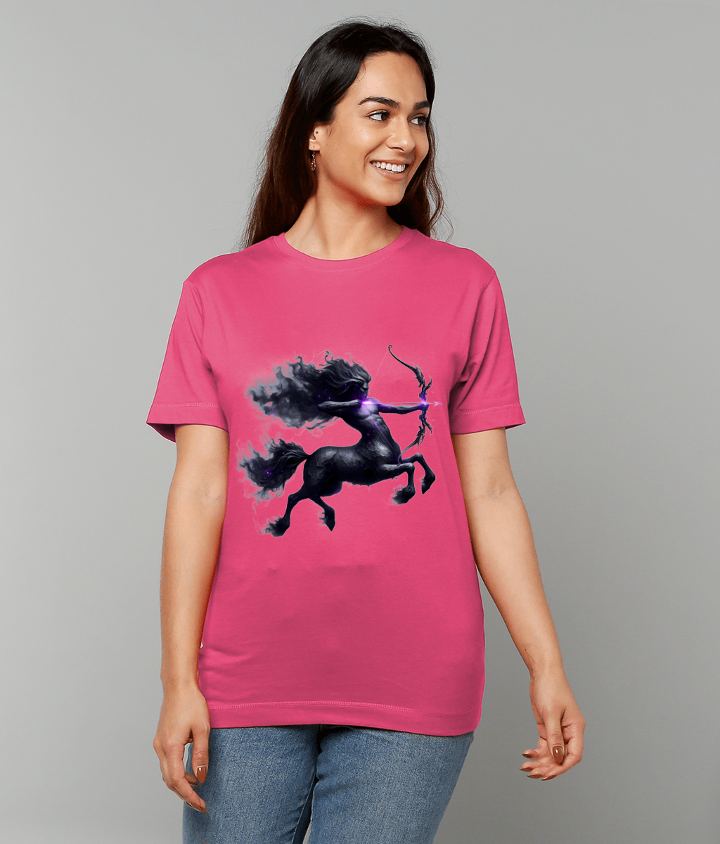 Magenta T-shirt displaying a dark centaur archer leaping right with a glowing purple bow; a smiling woman models it wearing jeans against a plain light gray studio background.