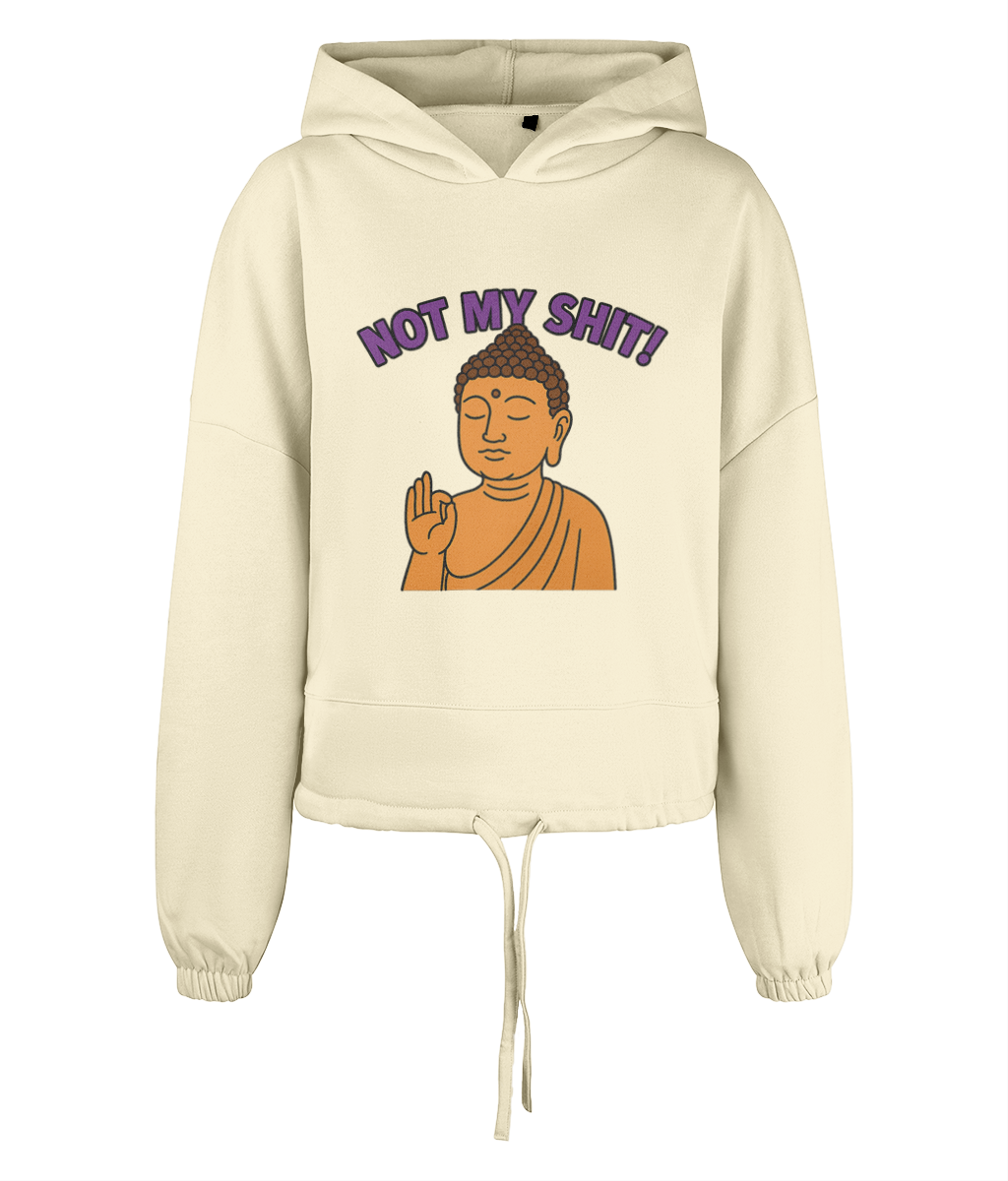 Cream hooded sweatshirt displays a centered cartoon Buddha raising a hand in blessing and the text "NOT MY SHIT!" arched above, photographed against a plain black background.