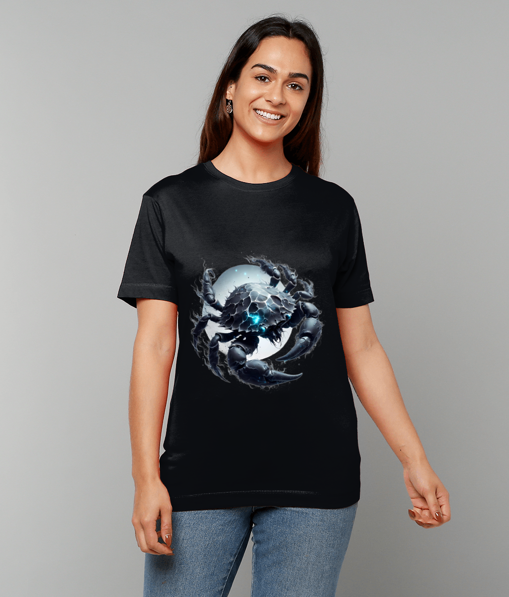 A woman wears a black T-shirt printed with a detailed dark crab illustration with glowing blue highlights centered over a pale circular moon motif against a plain gray background.