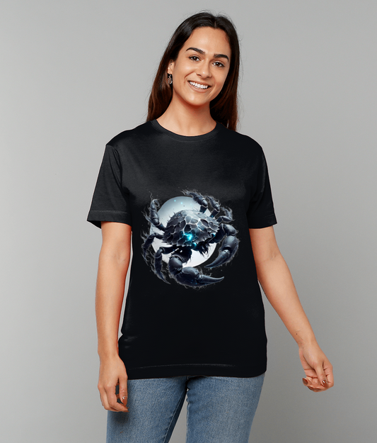 A woman wears a black T-shirt printed with a detailed dark crab illustration with glowing blue highlights centered over a pale circular moon motif against a plain gray background.