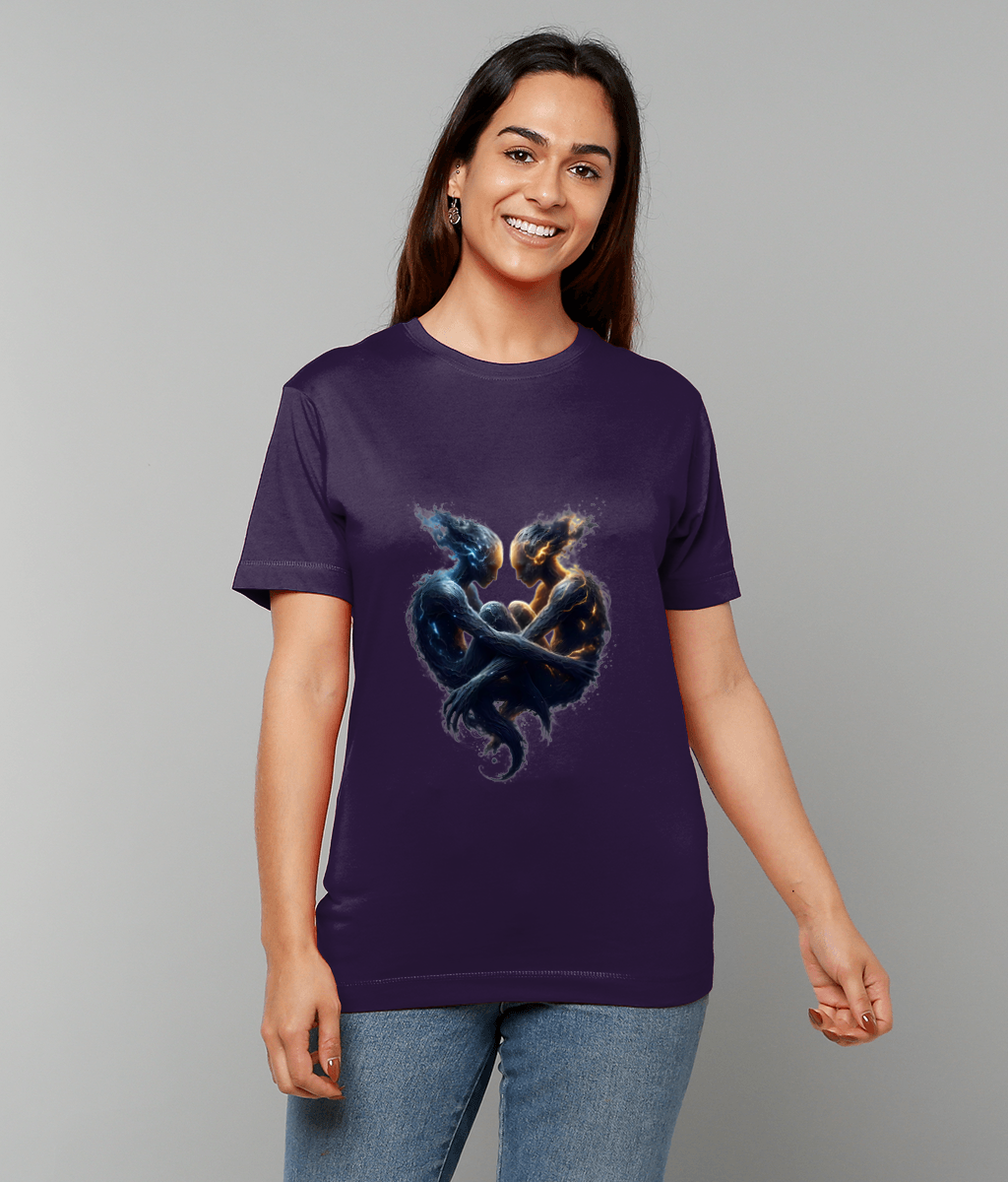 A purple T-shirt displays two entwined elemental figures, one blue, one ember orange, forming a heart while a smiling woman wears it against a neutral gray studio background.